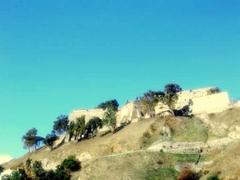 Historic Forte Gonzaga in Messina, Italy, with stone walls and scenic surrounding landscape