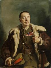 Portrait of Alexander in uniform holding cap in right hand wearing fur lined bomber-style leather jacket