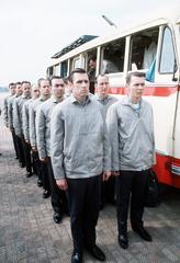 American POWs at Gia Lam Airport standing next to bus at prisoner exchange point