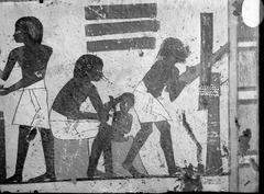 Detail of three ancient Egyptian craftsmen working, with the central craftsman carving an Isis knot from the tomb of Ipuky and Nebamun TT181