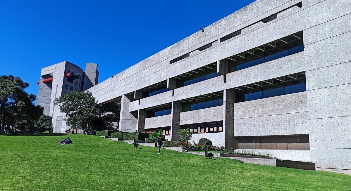 Facade of El Colegio de Mexico building with clear blue sky