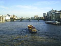 Southwark Bridge over River Thames with Tower Bridge in distance, London