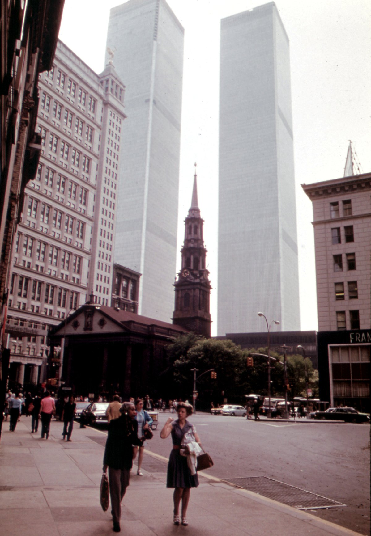 Historic St. Paul's Chapel on Lower Broadway with the World Trade Center Twin Towers in the background, New York City, 1973