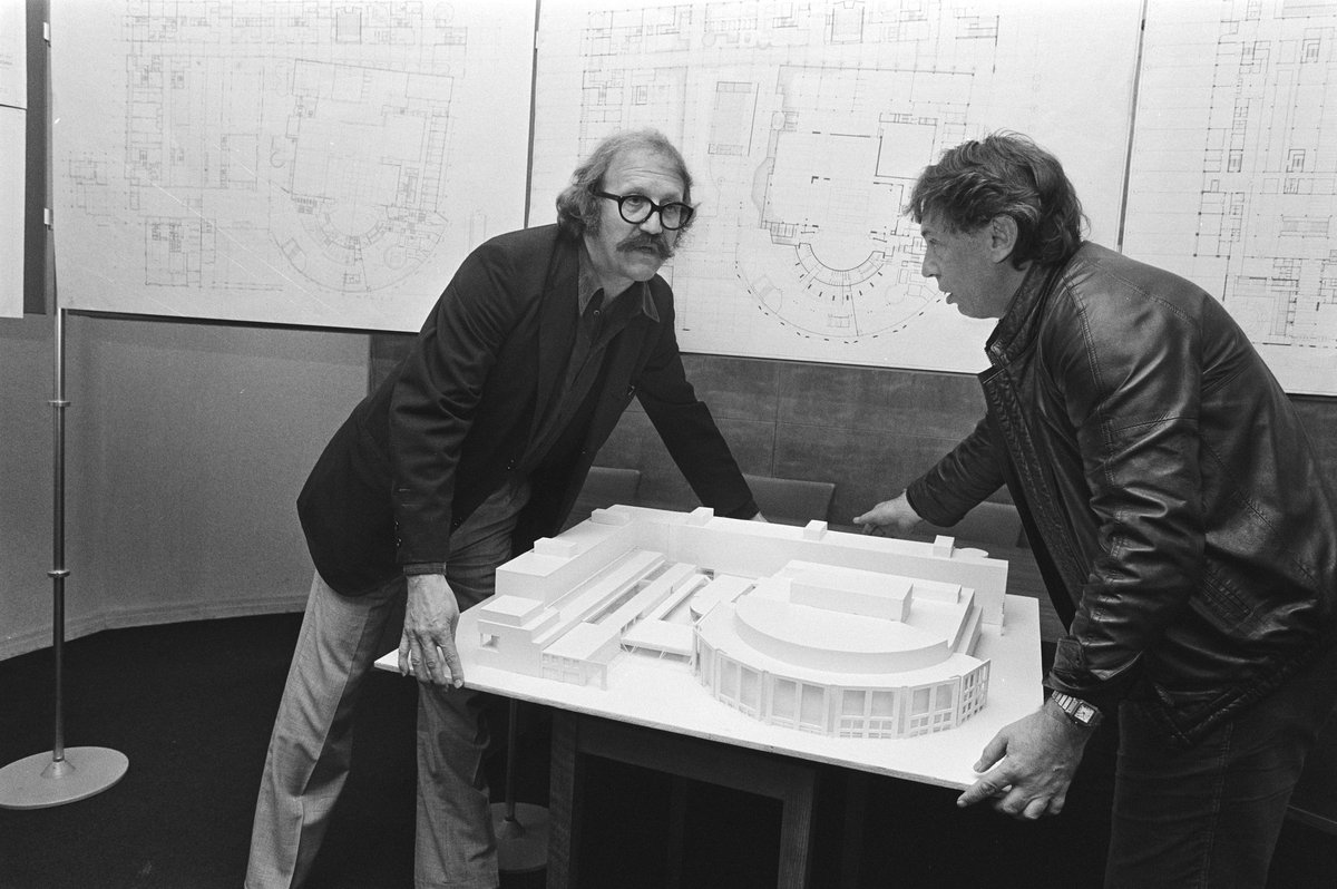 Architects Cees Dam and Wilhelm Holzbauer examining a building model during a meeting at the Muziektheater