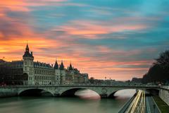 Sunset over the Seine River in Paris with iconic landmarks and serene reflections