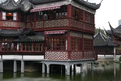 Pagoda in Yuyuan Garden surrounded by traditional Chinese architecture and lush greenery in Shanghai