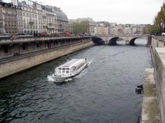 View of the Seine River with boats and historical buildings in Paris