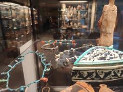 Ancient jewelry artifacts from Medelhavsmuseet displayed on a blue background