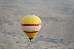 Aerial view of the Valley of the Kings in Luxor, Egypt during sunrise with floating clouds
