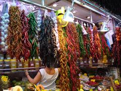 Entrance of Boqueria Market in Barcelona with vibrant colorful stalls and people