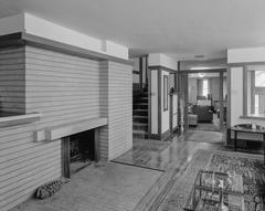 Historic Emil Bach House living room interior looking east with wooden furniture and large windows