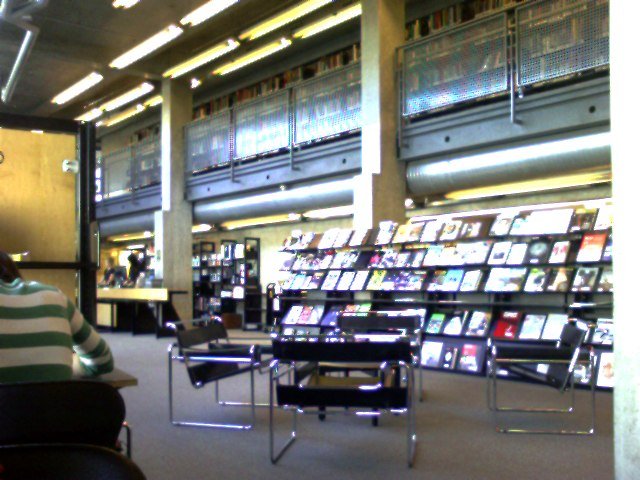 Inside view of the school library at Emily Carr University of Art and Design South building with bookshelves and seating area