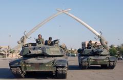 U.S. Army M1A1 Abrams Main Battle Tank and soldiers from 1-35 Armor posing under the Victory Arch in Ceremony Square Baghdad during Operation Iraqi Freedom 2003