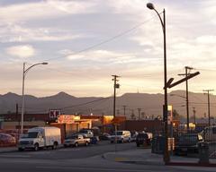 Sunset view looking south across San Fernando Road in Burbank towards Griffith Park with mountains in the distance