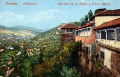 View of Granada cityscape with historic buildings under a colorful sunset sky