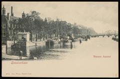 Several ships in the Binnen Amstel canal between Nieuwe Herengracht and Magere Brug bridge in Amsterdam around 1900