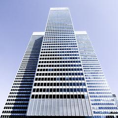 White skyscraper in Montreal against blue sky