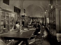 1913 image of the New England Conservatory library showing bookshelves and reading area
