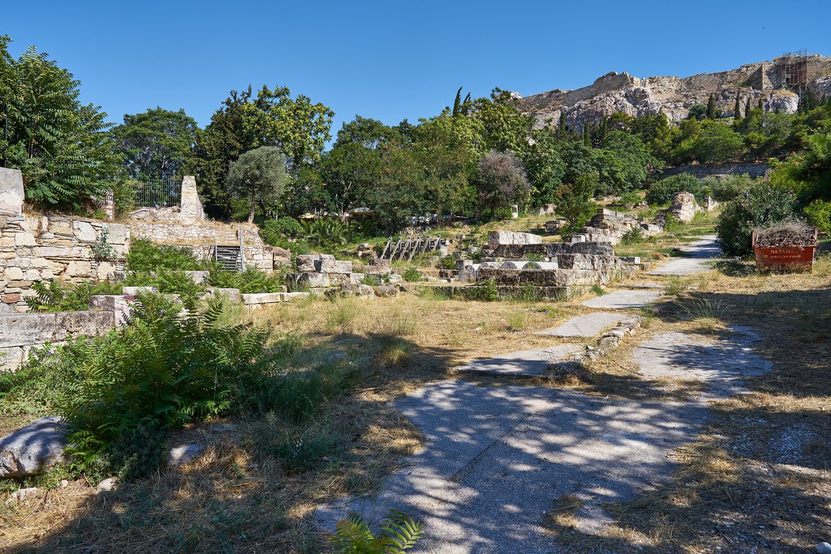 Ruins of the Eleusinion temple with surrounding rock foundations and retaining wall at the Ancient Agora of Athens