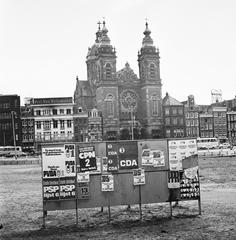 Election posters for municipal council elections at Amsterdam Central Station in 1974