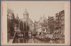 Historical view of Oudezijds Voorburgwal canal towards Armbrug bridge, Oudezijds Kolk and Sint Nicolaaskerk church in Amsterdam, circa 1890-1900