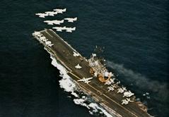 Eight U.S. Navy Douglas A-4E Skyhawks from Attack Squadron 45 flying over aircraft carrier USS Intrepid