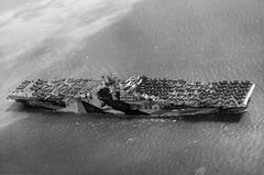 USS Intrepid CV-11 aircraft carrier underway with deck full of planes near San Francisco in June 1944
