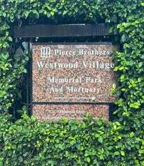 Westwood Village Memorial Park Cemetery entrance sign surrounded by greenery