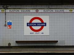 Grey platform wall tiling and historic Metropolitan and Circle Lines station frieze at Euston Square station
