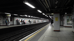 Euston Square station westbound platform with 1930s orange and black bordered Metropolitan Railway tiles