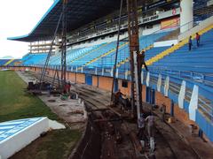 Stadium renovation with expanded grandstands under clear blue sky