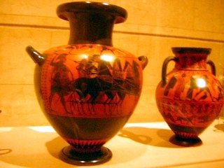 Ancient Greek pottery with intricate black-figure designs