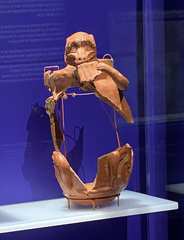 Barrel-shaped vase with applique decoration featuring a musician monkey