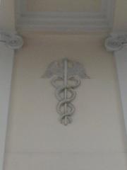 Caduceus relief on the Palace of the Ministry of Revenues and Treasury facade in Warsaw, Poland