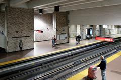 Atwater metro station platform with green signage and empty tracks on a clear day
