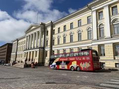 Main building of Helsinki University next to Senate Square with tourist hop on hop off bus