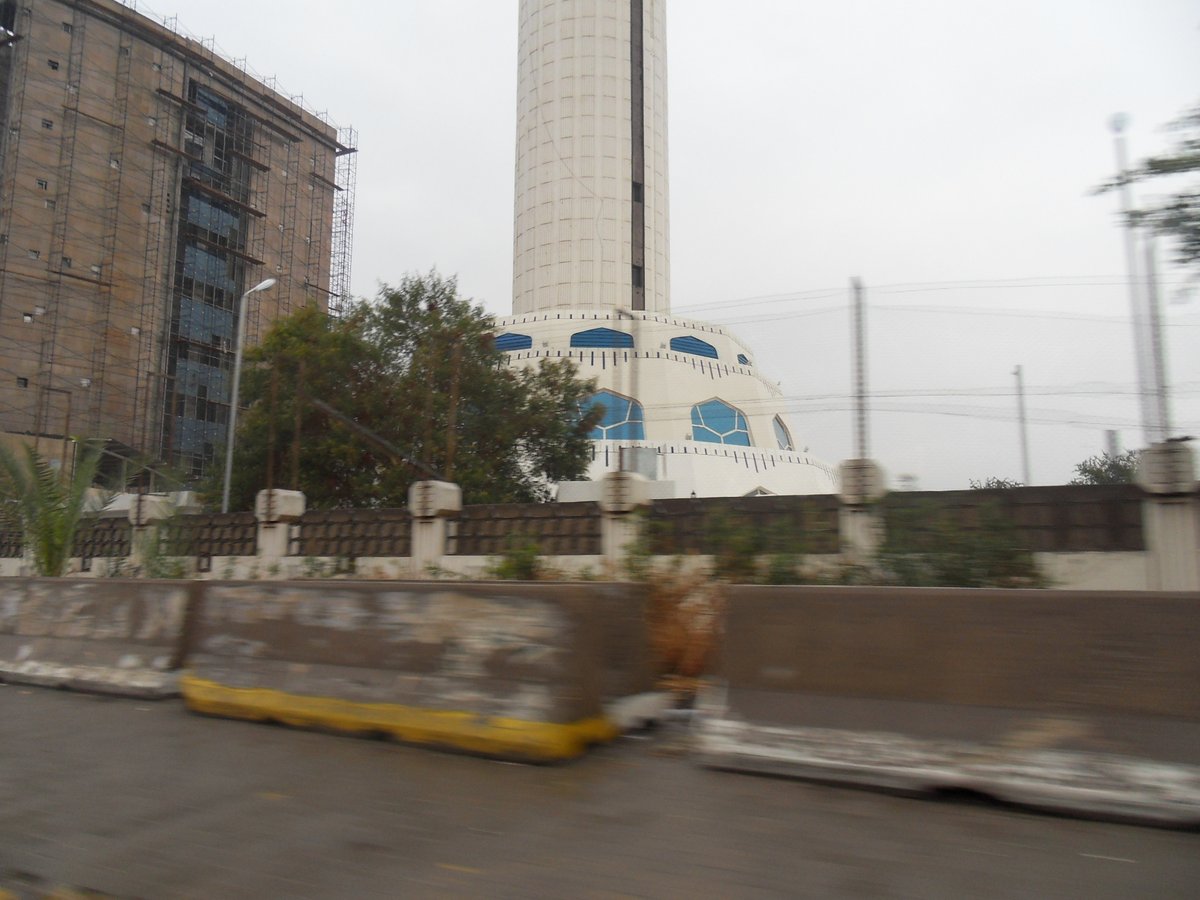 Baghdad Tower at Ma'moon Center with modern architecture against a partly cloudy sky