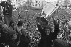 Ajax football player Arie Haan holding the Europacup I trophy during celebration on the balcony of Stadsschouwburg in Amsterdam, June 1, 1972