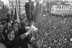 Johan Cruijff and Piet Keizer holding the Europacup I trophy on the balcony of the Schouwburg in Amsterdam after Ajax won the final in 1972