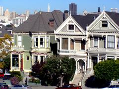 Colorful Painted Ladies Victorian houses in San Francisco with city skyline in background