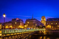 Golden hour view of the Seine river and Hotel de Ville in Paris after sunset