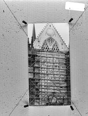 Protest slogans painted on plastic covering the facade of Nieuwe Kerk in Amsterdam in 1971 by activist group 'De lastige Amsterdammer' against metro construction, demolition, and cars