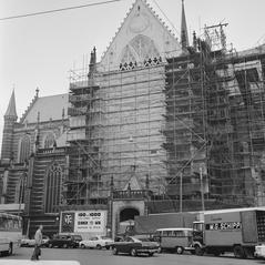 Protest slogans painted on plastic covering of Nieuwe Kerk Amsterdam by activist group De lastige Amsterdammer against metro, demolition, and cars