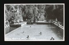 People enjoying Radium Hot Springs pool in British Columbia with others watching from the side