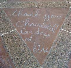 Colorful chalk writing on pavement thanking Chamizal for a day of kids