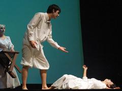 Actors performing on stage in a play by Cambalache Teatro