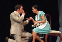 Actors performing on stage in a theatrical play