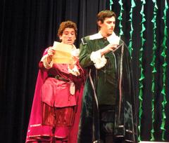 Actors performing on stage in a theatrical play 