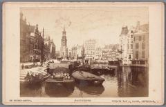 View of the Amstel River from Halvemaansbrug to Muntplein in Amsterdam with historical buildings including 'De Nederlanden van 1845' and the Munttoren tower