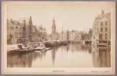 Historic view of the Amstel river from Halvemaansbrug bridge to Muntplein and Munttoren tower in Amsterdam around 1880